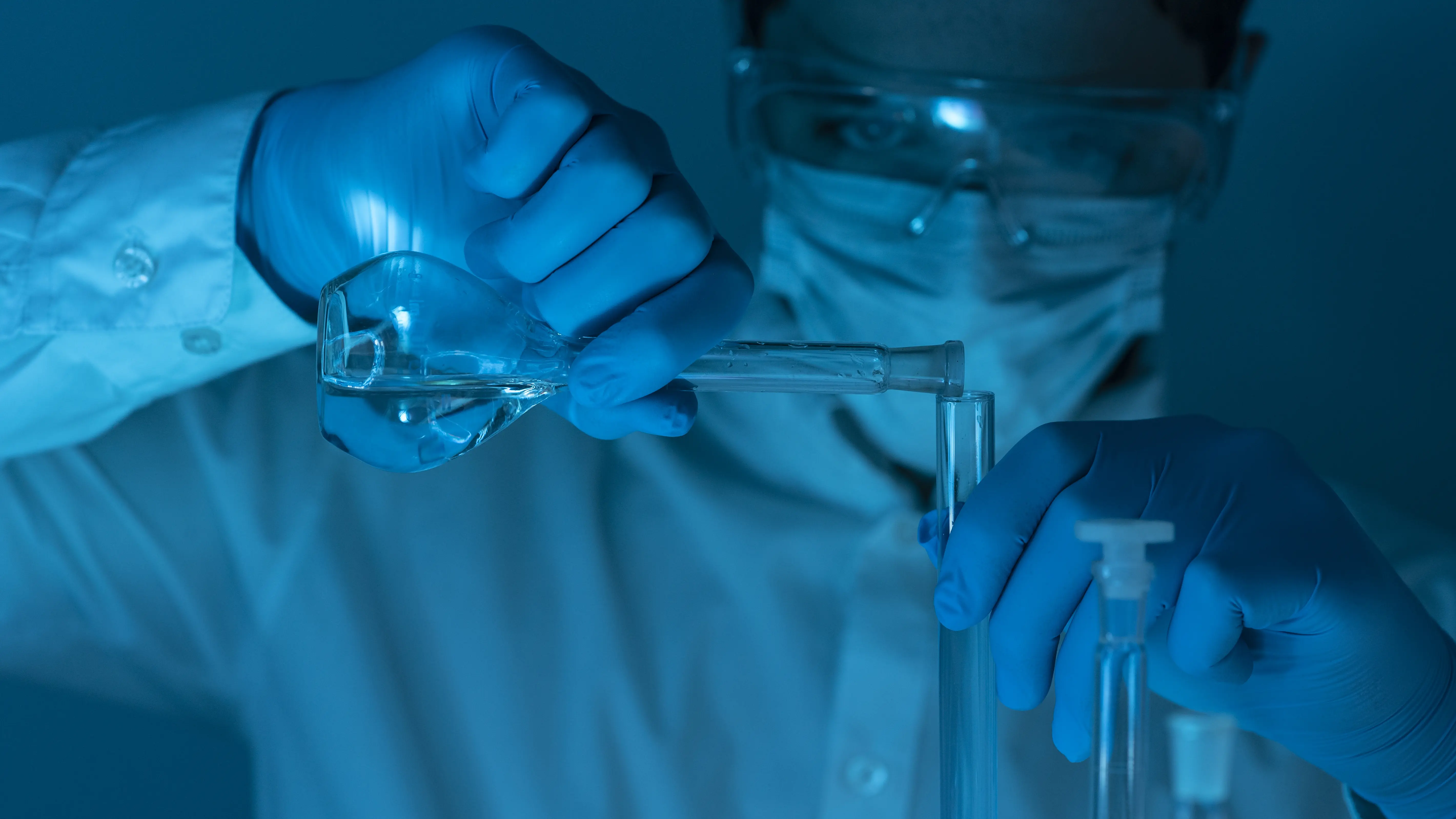 Researcher working with glassware in a laboratory